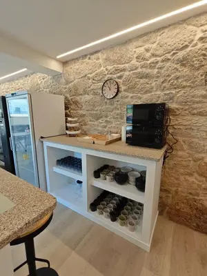 a counter in a coffee shop with a clock on the wall at Villa Vieira in A Escravitude