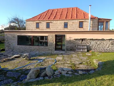a stone house with a hose in front of it at O Campo DaFolla in Caroy