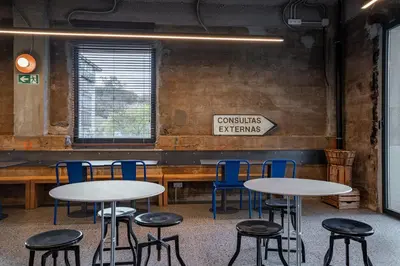a room with two tables and chairs and a sign at Lemonade Stays Santiago de Compostela in Santiago de Compostela
