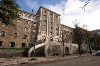 a large brick building with stairs in front of it at Lemonade Stays Santiago de Compostela in Santiago de Compostela