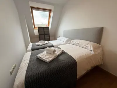 a bedroom with two beds with towels on top of them at Oktheway O Burgo in El Burgo