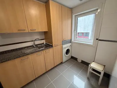 a small kitchen with a washing machine and a window at Oktheway O Burgo in El Burgo