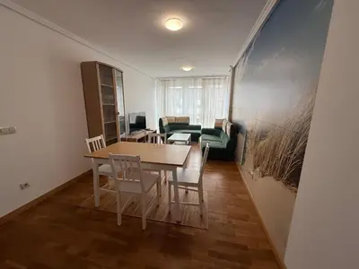 a dining room with a table and chairs and a couch at Oktheway O Burgo in El Burgo