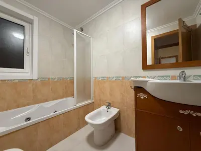 a bathroom with a sink and a toilet and a mirror at Oktheway O Burgo in El Burgo