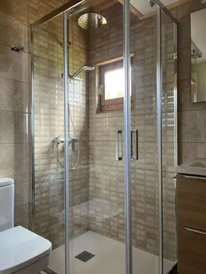 a shower with a glass door in a bathroom at Apartamentos Playa Frejulfe in Paderne