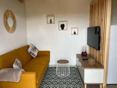a living room with a couch and a table at Apartamentos Playa Frejulfe in Paderne