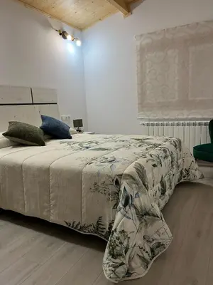 a bedroom with a bed with a blanket on it at Apartamentos Playa Frejulfe in Paderne