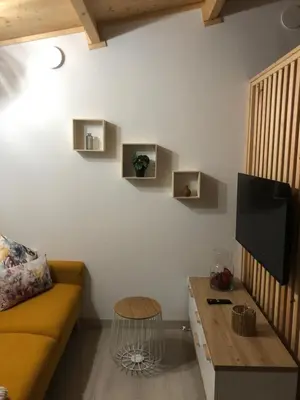 a living room with a couch and a table at Apartamentos Playa Frejulfe in Paderne