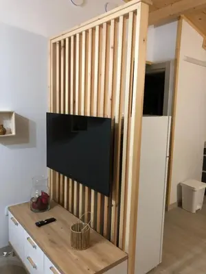 a wall with a flat screen tv in a room at Apartamentos Playa Frejulfe in Paderne