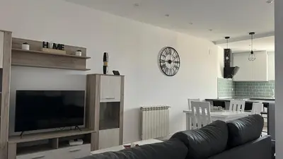 a living room with a couch and a flat screen tv at Apartamento nuevo casco antiguo in Ponferrada