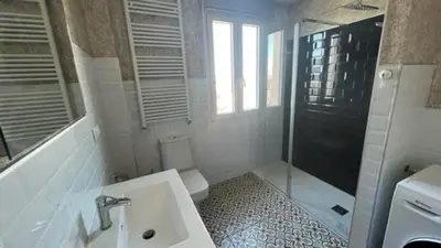 a bathroom with a toilet and a sink and a shower at Apartamento nuevo casco antiguo in Ponferrada