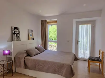 a bedroom with a large bed and a window at Casa Rural Abreu Do Louro in Arbo