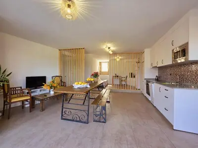 a kitchen and living room with a table and a dining room at Casa Rural Abreu Do Louro in Arbo
