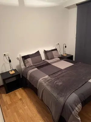 a bedroom with a large bed and two lamps at casa habana in Carballino