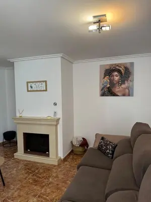 a living room with a couch and a fireplace at casa habana in Carballino