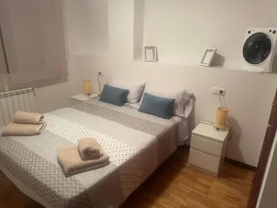 a bedroom with two beds and a clock on the wall at casa habana in Carballino