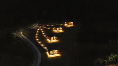 a group of cars parked on a road at night at Cabañas Ribeira Sacra in Parada del Sil