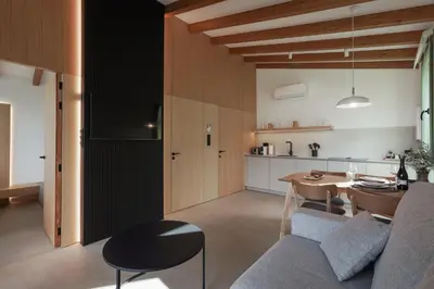 a living room and kitchen with a couch and a table at Cabañas Ribeira Sacra in Parada del Sil
