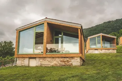 a house sitting on top of a grass field at Cabañas Ribeira Sacra in Parada del Sil