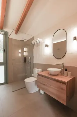 a bathroom with a sink and a toilet and a mirror at Cabañas Ribeira Sacra in Parada del Sil