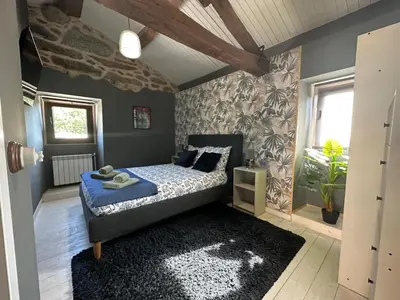 a bedroom with a bed with a blue comforter at Casa Camu in Covelo