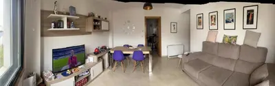 a living room with a table and purple chairs at Recuncho do Susiño in Foz