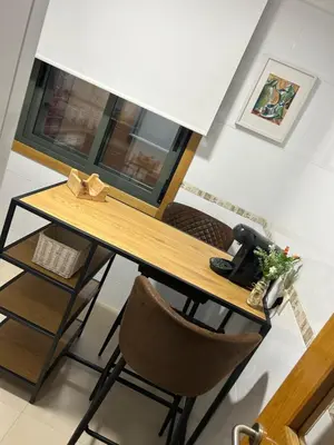 a dining room table with a chair and a desk at Recuncho do Susiño in Foz