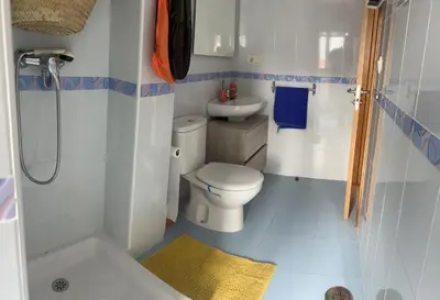 a small bathroom with a toilet and a sink at Recuncho do Susiño in Foz
