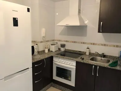 a kitchen with a sink and a stove at Recuncho do Susiño in Foz