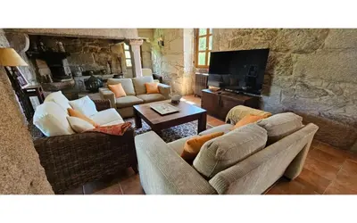 a living room with two couches and a television at O canto do grilo in Valeije