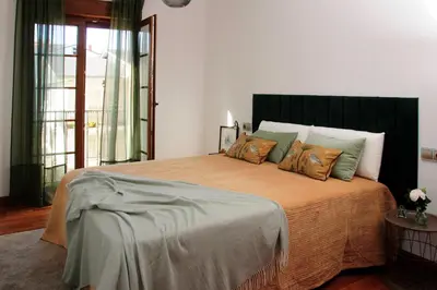 a bedroom with a large bed with several pillows at Silleda Via da Plata in Silleda