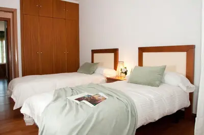 a bedroom with two beds with a magazine on them at Silleda Via da Plata in Silleda