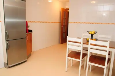a kitchen with a refrigerator and a table and chairs at Silleda Via da Plata in Silleda