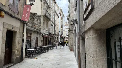 an alley with tables and chairs in a city at Apartamento Ourense Vello - en el centro del casco histórico in Ourense