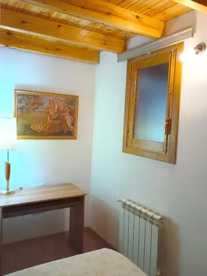 a bedroom with a table and a mirror on the wall at A Casa da Boa Xente VUT-OU-1329 in Verín