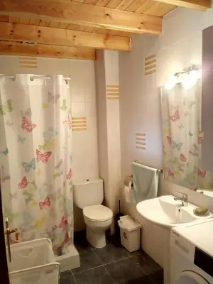 a bathroom with a toilet and a shower curtain at A Casa da Boa Xente VUT-OU-1329 in Verín