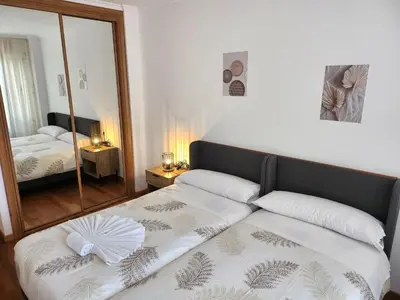 a bedroom with a bed and a large mirror at CREDENCIAL Avda BECERREA in Sarria
