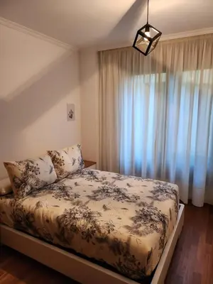 a bedroom with a bed and a large window at CREDENCIAL Avda BECERREA in Sarria
