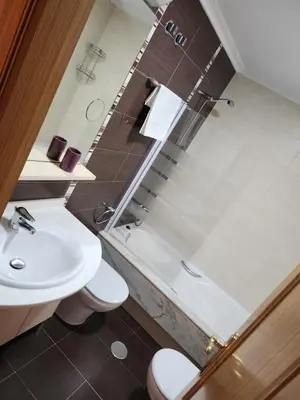 a bathroom with a sink and a toilet and a shower at CREDENCIAL Avda BECERREA in Sarria