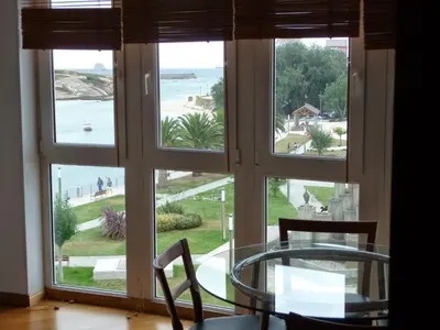 a room with a window with a view of the ocean at Parque San Ciprián in San Ciprián