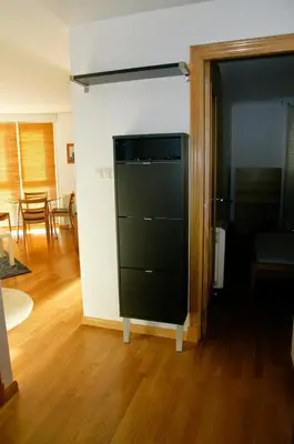 a living room with a black cabinet in a room at Parque San Ciprián in San Ciprián