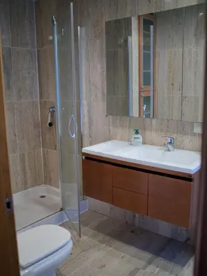 a bathroom with a sink and a shower and a toilet at Parque San Ciprián in San Ciprián
