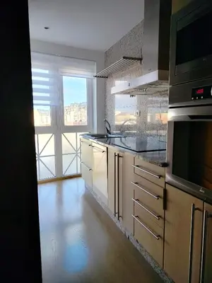 a kitchen with a sink and a large window at Parque San Ciprián in San Ciprián