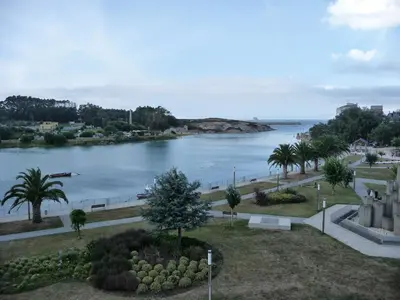 a view of a body of water with palm trees at Parque San Ciprián in San Ciprián