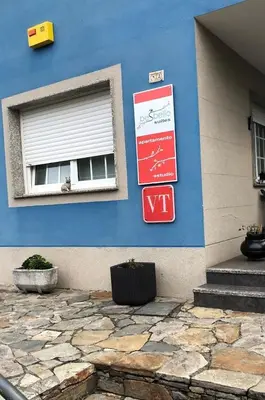 a blue building with signs on the side of it at Besbello Suites - Estudio in Santiago de Compostela