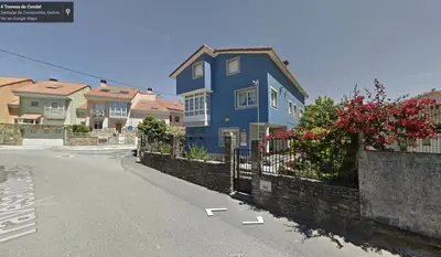 a blue house on the side of a street at Besbello Suites - Estudio in Santiago de Compostela