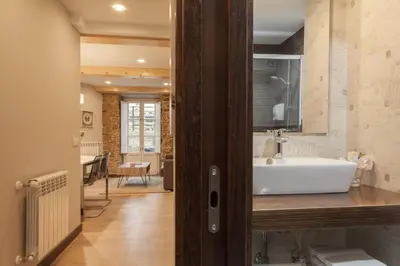 a bathroom with a white sink in a room at Nova Compostela Apartments in Santiago de Compostela