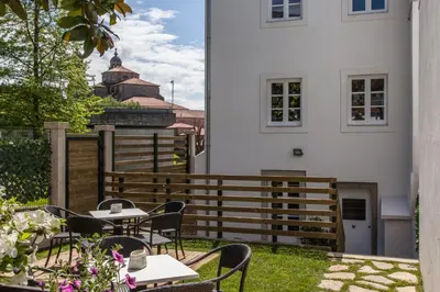 a patio with tables and chairs next to a building at Nova Compostela Apartments in Santiago de Compostela