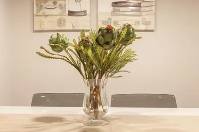 a vase with flowers in it sitting on a table at Nova Compostela Apartments in Santiago de Compostela