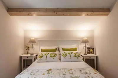 a bedroom with a large bed with two night stands at Nova Compostela Apartments in Santiago de Compostela